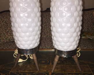 An unusual pair of Mid-Century Modern lamps. The plastic column shades and wood and metal base are in great vintage condition.