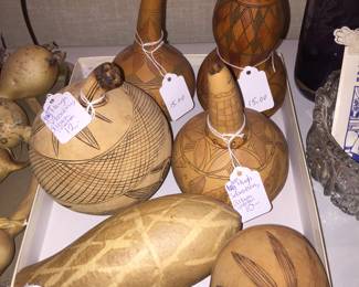 Decorated gourds feature designs that appear to be inspired by Native American and African art. 