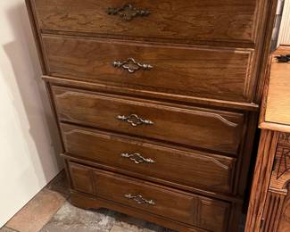 One of several dressers in this sale, this one has some darker wood pieces.