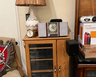 There are several items to point out in this photo.    The stereo components inside the media cabinet, the bookcase stereo & CD player, the lamp sitting on top of the cabinet, and hints of other items to the left and right.