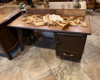 In this photo, a simple desk is seen, as well as a few decorative items, including a crystal ball.