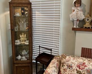 There is a smaller corner display cabinet in another corner of the living room.