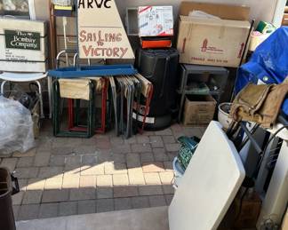 Yes, that is a model sailboat (probably a prop) in the background.  There is also a card table, and a leather toolbag.