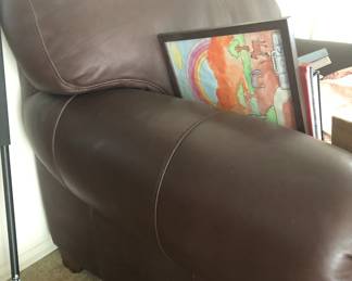 SIDE OF BROWN LEATHER CHAIR