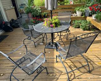 Black iron patio set with four spring chairs and cover Umbrella. Sold separately maybe