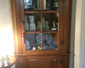 Small cherry single door corner cabinet. 