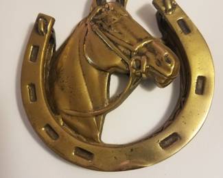 Classic old brass horse door knocker.