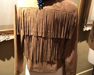 Fringed petite faux leather jacket with closure hook and eye.