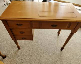 Sewing cabinet with Singer sewing machine.