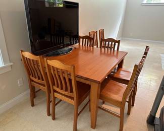 G13 - $350. Square solid wood table with 8 chairs. Measures 53" square x 30" tall. 