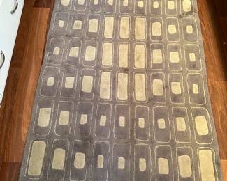 G83 - $150. Wool area rug. Measures 5.5' x 3.5' 