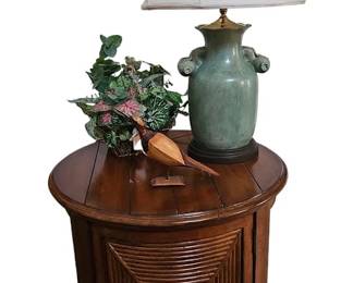 Round wooden and rattan end table with porcelain lamps and handcarved shore bird