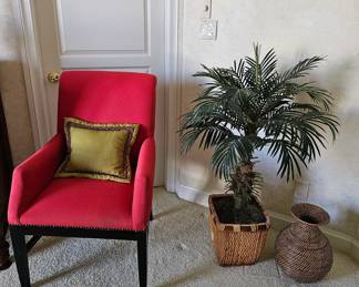 One of a pair of red occasional chairs with silk palm and rattan basket
