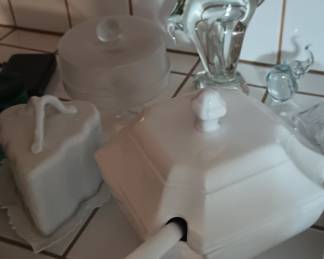 glass elephant next to covered soup bowl with ladle 