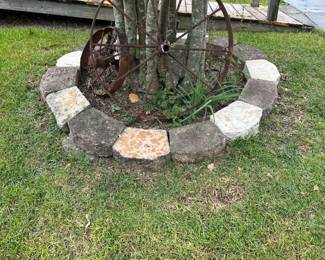 Large wagon wheel , small tractor wheel, and farm implement