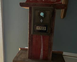 Antique mailbox encased with coca cola signage , numbers to the combination is on the backside