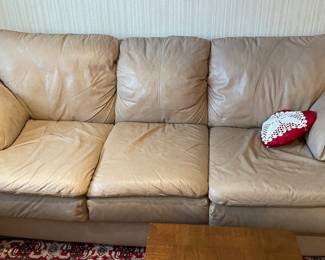 Cream colored leather sofa, has a matching love seat
