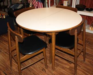 42" round mid-century modern dinette table and four vinyl-covered chairs; plus one 12" leaf