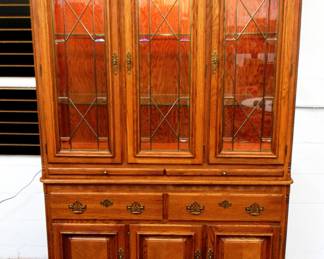 Beautiful Oak China Cabinet, lights up. Comes in 2 pieces & is in excellent condition. 