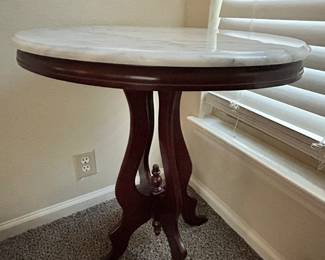 This lovely oval accent table elevates the room. The marble top adds a special touch 