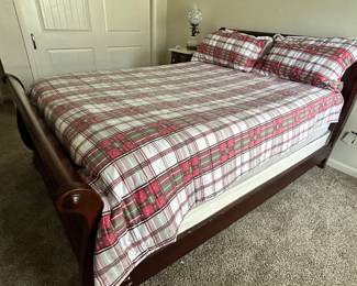 This like-new sleigh bed is a beautiful dark wood with and can easily match your decor 