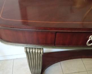 Close up of mahogany Table with silver accents.