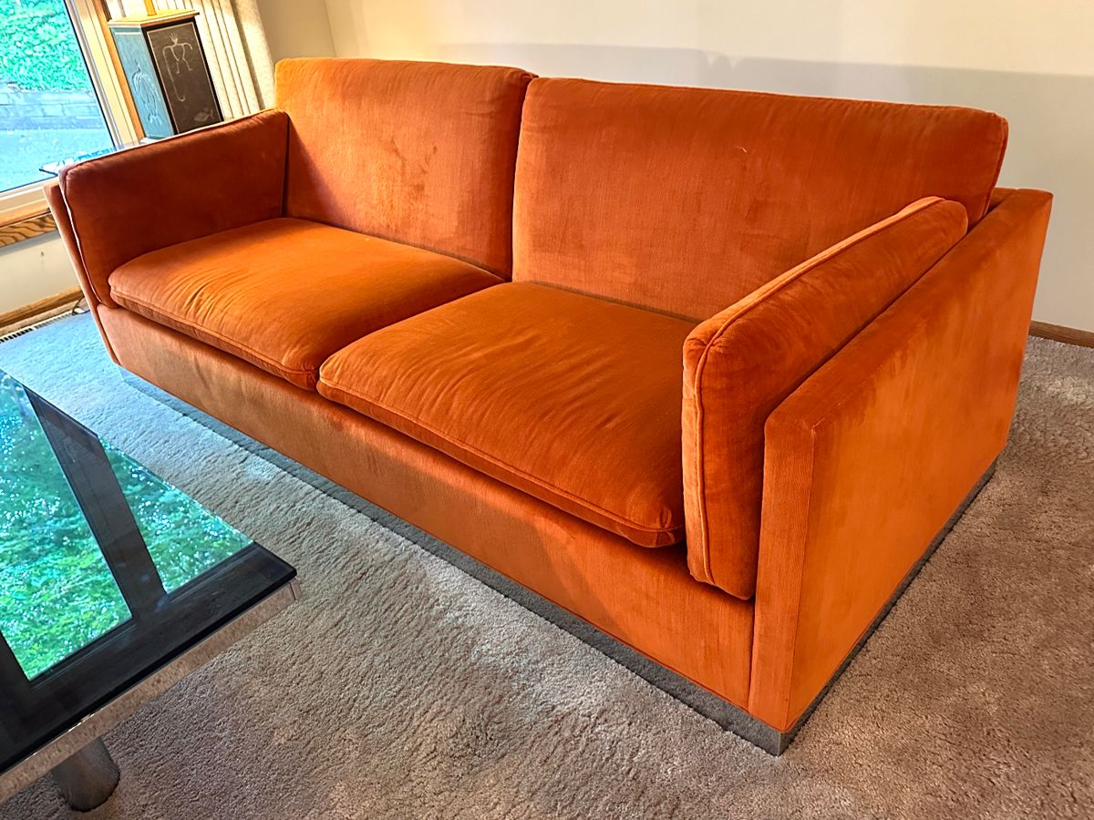 Vintage Mid Century Modern Jack Cartwright Sofa. Wow! This is an amazing mid century sofa in very good condition. 

Features luxurious clean orange upholstered seating paired with a chrome platform base. 

Measures 82.5" x 34.5". 