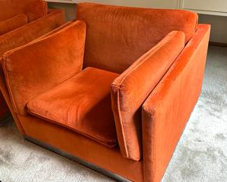 Pair of Mid Century Modern Jack Cartwright Chairs upholstered in a fantastic retro orange shade paired with a chrome base.  Each measuring about 37” x 34.5”. 

Items in vintage condition with some light wear including one having some wear to the fabric on the edges