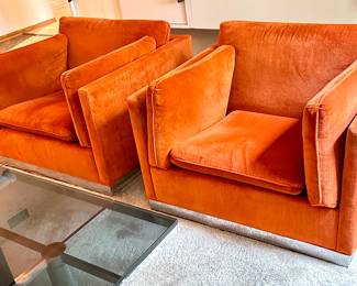 Pair of Mid Century Modern Jack Cartwright Chairs upholstered in a fantastic retro orange shade paired with a chrome base.  Each measuring about 37” x 34.5”. 

Items in vintage condition with some light wear including one having some wear to the fabric on the edges