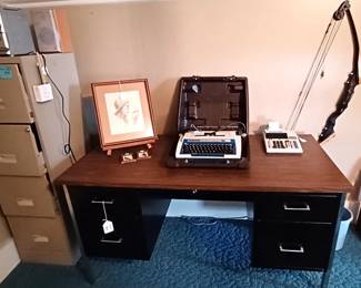 Steelcase style desk, 4-drawer file cabinet, a nice compound bow,  and an interesting shelf
