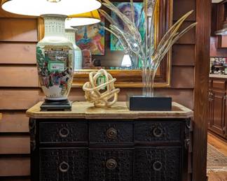 One of a pair of Theodore Alexander faux croc drawer chests, with brass-banded marble top, one of a pair of Asian Porcelain table lamps,  Bird of Paradise boron glass Hans Godo Frabel sculpture, Frabel gold-flecked love knot and vintage wooden framed wall mirror. 