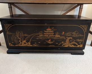 AMAZING 1940's hand-painted black lacquer Lane cedar chest. Make sure to read the story behind the inspiration for this Lane chest. "The decoration on this Lane is a reproduction of a hand painting chest and depicts a scene from the old love story of the princess Liu-Chang-tu, who fell in love with a fisherman of a nearby village. The girl was the daughter of a powerful prince who was ambitious to se his daughter marry a man of high rank and wealth, but she had lost her heart to Wong, the fisherman. Their courtship was carried on with messages smuggled back and forth by a trusted servant who also lived in the village. Each day, Liu-Chang-tu would wave to Wong as he poled his boat on the way to his nets and each evening when he returned. This continued for years as Liu-Chang-tu rejected one by one each of the suitors her father was very angry.
