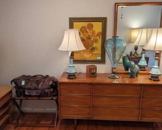 9-drawer fruitwood dresser, w/matching mirror, by Dixie Furniture Co., pair of hand-painted Tiffany blue porcelain and brass table lamps, Van Gogh "Sunflowers", men's vintage Bed/Stu leather bag on wooden luggage stand, wooden end table by Fine Arts Furniture, Grand Rapids, MI, and large hand-blown Murano glass vase.