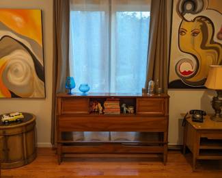 Full size headboard, w/sliding wooden panels, by Dixie Furniture Co., pair of hand-painted original oils on canvas by Amy Dandy and MCM drum table side table,  "Empress", by Thomasville.