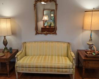 LOVE that vintage French Provincial sofa, in all-original condition! The end table are both by Weiman Furniture Co.,  glorious table lamps by Rembrandt and Stiffel, both with original shades and diffusers. French wall mirror freshly stolen from Versailles and flown over by the Concorde specifically for this estate sale.