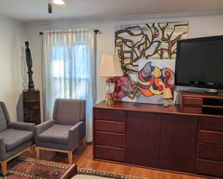 Matching dresser, by John W. Provence, of Heirloom Artisans, pair of grey upholstered armchairs that recline, Henredon Asian-inspired wooden display stand, one of a pair of vintage Stiffel brass/glazed ceramic table lamps and a vintage original oil on canvas of a Parisian street scene.