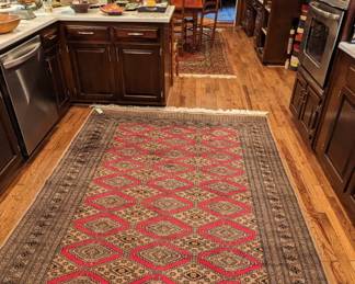 Long view of the kitchen and eat-in breakfast area and the hand-woven Bokhara wool rug. 