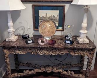 Framed antique French hand-woven hunt scene tapestry, carved wood/marble console table with stretcher, pair of Italian marble table lamps, four Frabel Studios sculptures, Chihuly-style glass tube and an amazing, one-of-a-kind artist-signed, gold-flecked Murano glass 12" diameter orb, w/under light - gorgeous (and OMG heavy!) night light.