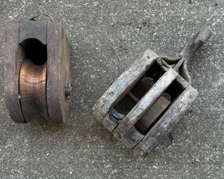 Several vintage wood and metal pulleys 
