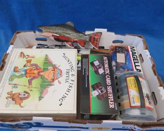 Lot 64. Magellan hand-held GPS, card shuffler, and more