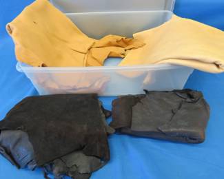 Lot 75. Four pieces of tanned deer hides and a Sterilite container