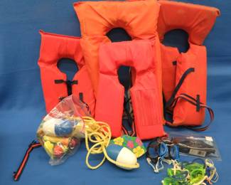 Lot 309. Four life jackets, swim goggles, and a floating rope