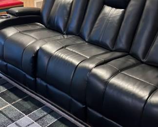 Black leather motorized couch with recliners, cup holders on ends $350