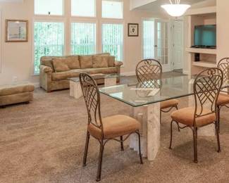 Pictured are the Florida Keys coral dining set and side table as well as palm tree themed sofa, loveseat and ottoman and lamps, Wicker buffet, Florida and travel themed art.