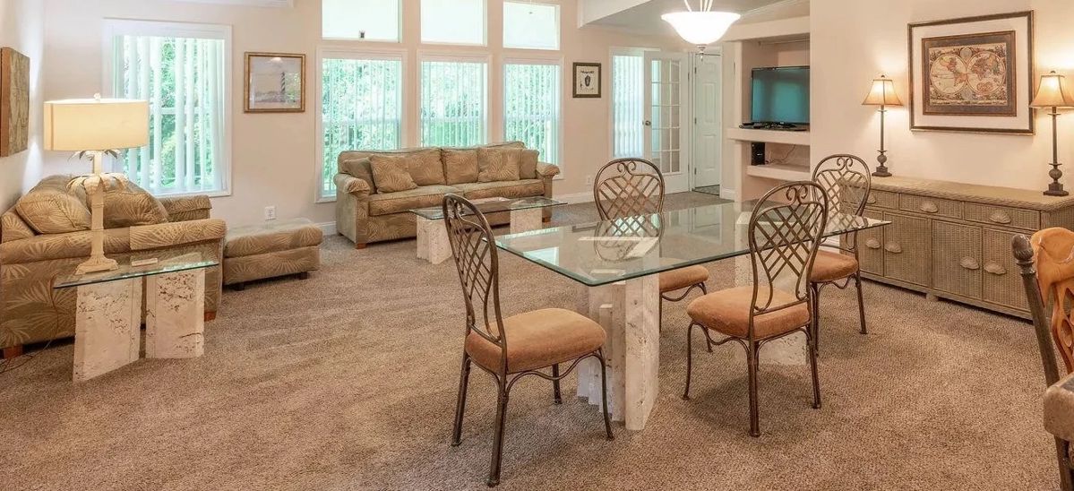 Pictured are the Florida Keys coral dining set and side table as well as palm tree themed sofa, loveseat and ottoman and lamps, Wicker buffet, Florida and travel themed art.