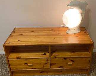 Wooden low dresser and dolphin lamp.