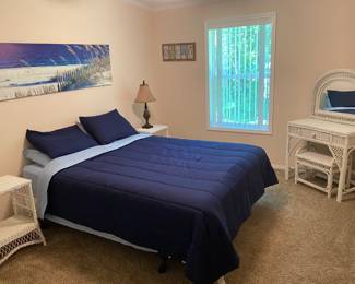 Queen size mattress and boxspring set, Full set of bedding. Wicker side tables, pineapple shaped lamp and beach artwork and decor.