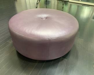 this large, leather ottoman is a darker shade than appears in the picture