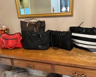 Quite a few designer handbag, such as coach, and Michael Kors. The red bag is by London fog.