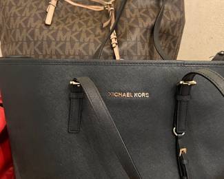 Michael Kors purses. There’s also a Gold, Michael Kors bag and an additional Michael Kors wallet and make up bag as well.